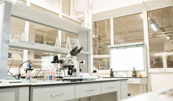 Laboratory place with glassware, modern devices and optical instruments used for scientific research
